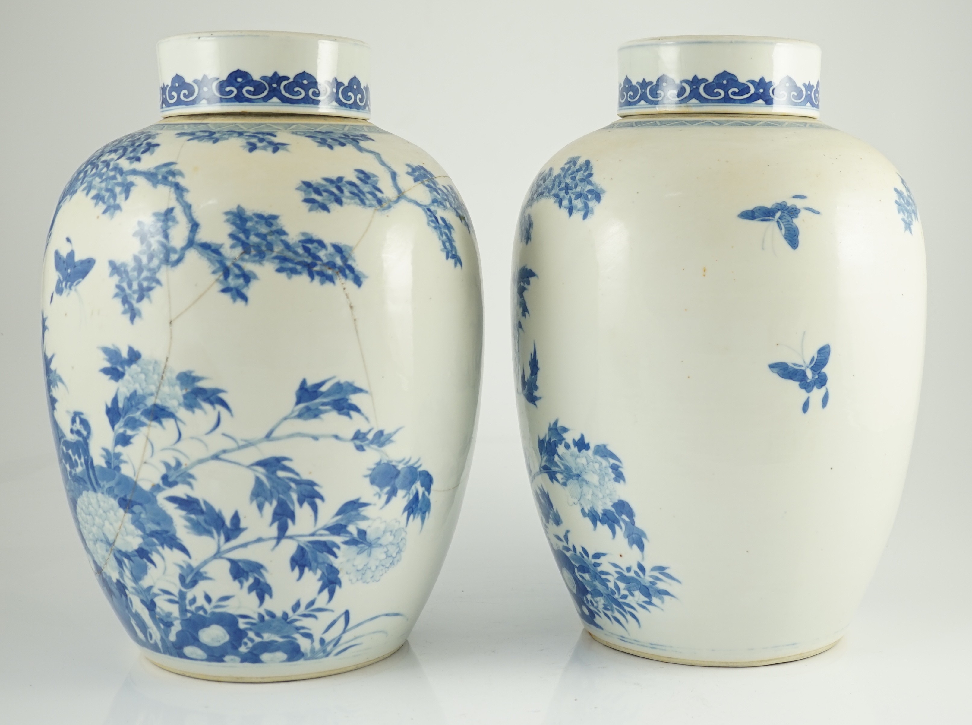 A pair of large Chinese blue and white ovoid jars and associated covers, 19th century, 34.5cm high, damage and repairs